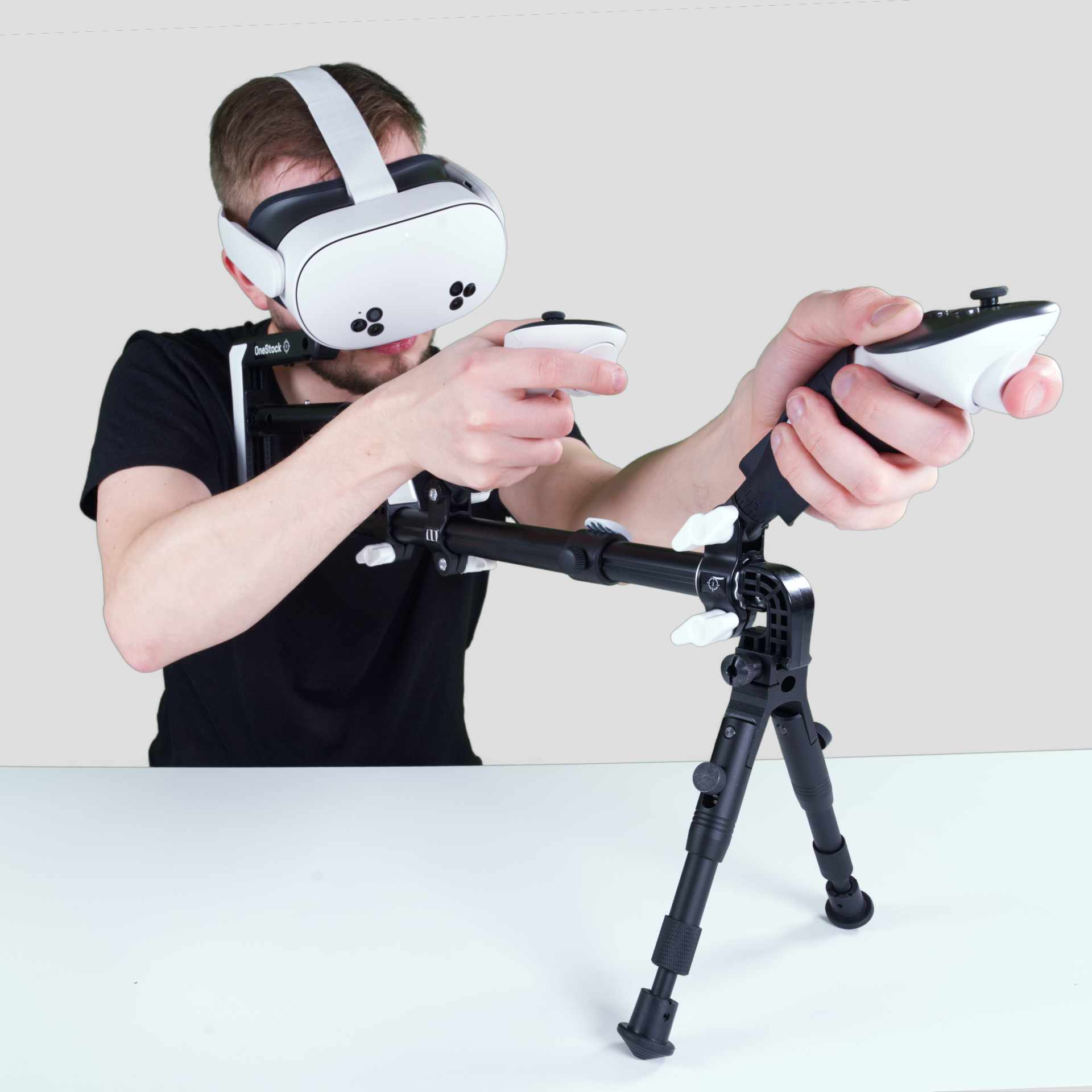 Man holding a Wield VR OneStock VR gunstock Meta Quest model with bipod add-on on a table mounted